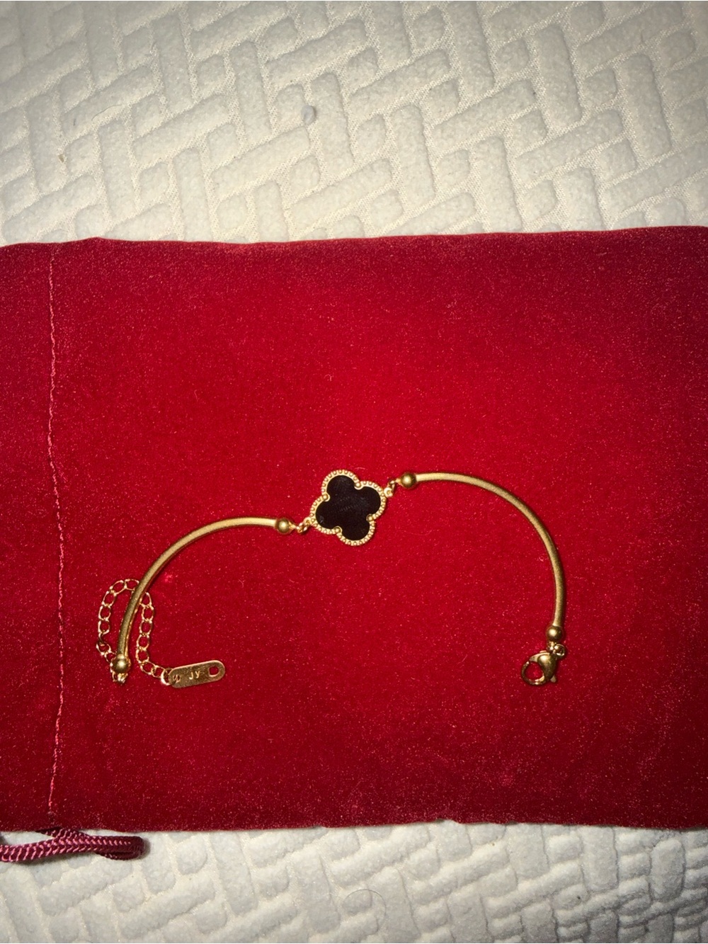 Gold Toned Bracelet with Black Clover Motif